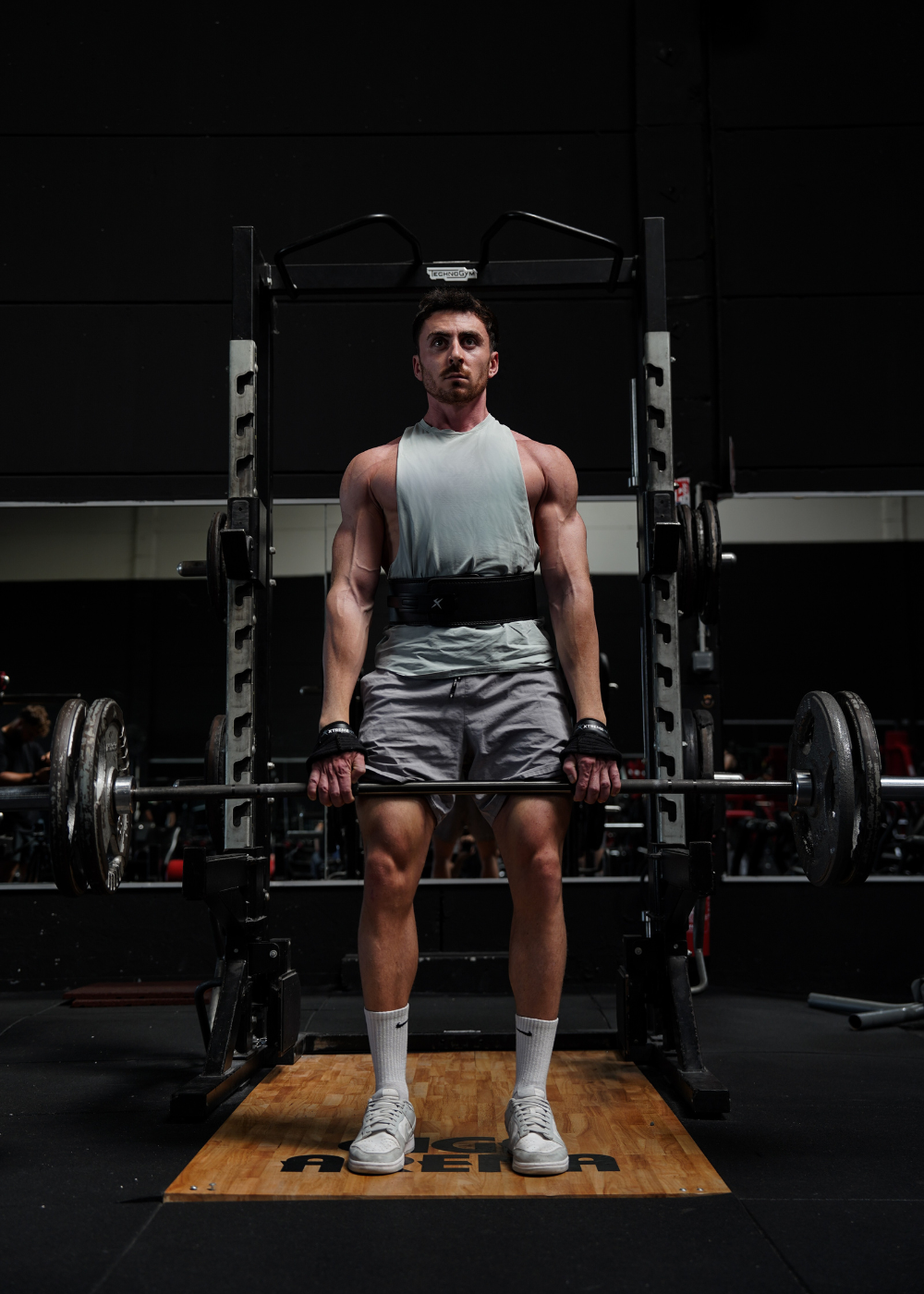 Athlète xtremefit faisant un soulever de terre avec ceinture powerlifting et sangles de tirage pour la musculation